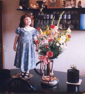 Girl and vase on the table.